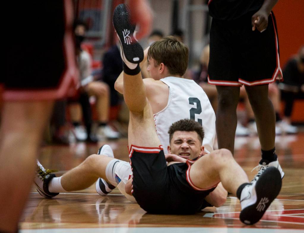 Mountlake Terraces Chris Meegan grimaces after colliding with Stanwoods John Floyd during Thursdays game in Stanwood. (Olivia Vanni / The Herald)