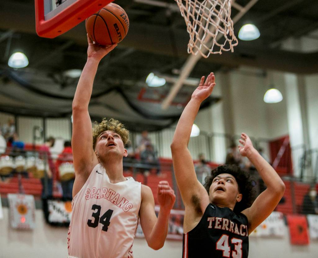 Stanwoods Kaeden McGlothin makes a layup during Thursdays game in Stanwood. (Olivia Vanni / The Herald)