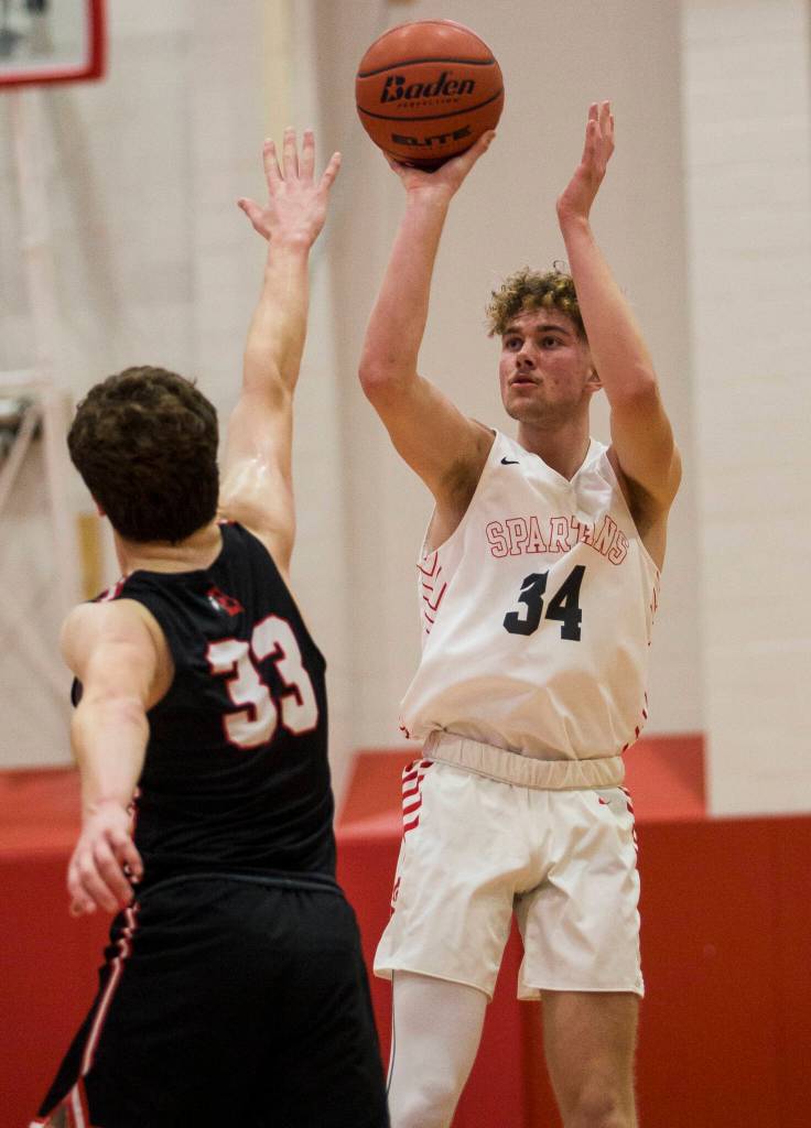 Stanwoods Kaeden McGlothin makes a three-point shot during Thursdays game in Stanwood. (Olivia Vanni / The Herald)