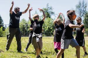 Jeff Thoreson cheers with his students after his class wins a tug-o-war game on Thursday, June 17, 2021 in Snohomish, Wa. (Olivia Vanni / The Herald)