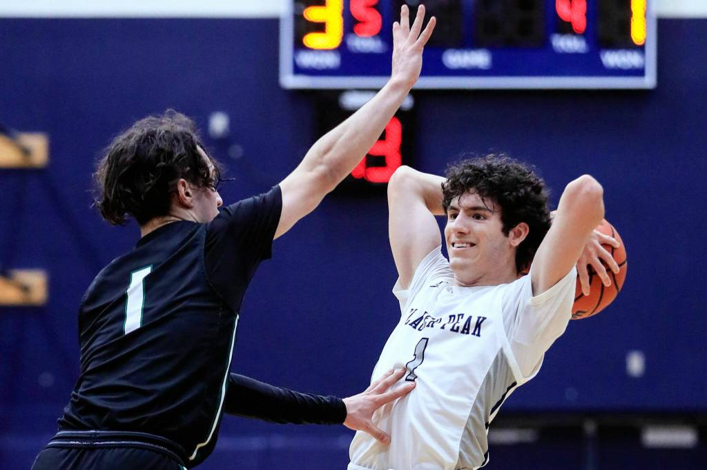 Jacksons Drilon Veliu defends with Glacier Peaks Aidan Davis looking to pass Friday evening at Glacier Peak High School in Snohomish, Washington on January 21, 2022. The Grizzles won 57-54. (Kevin Clark / The Herald)