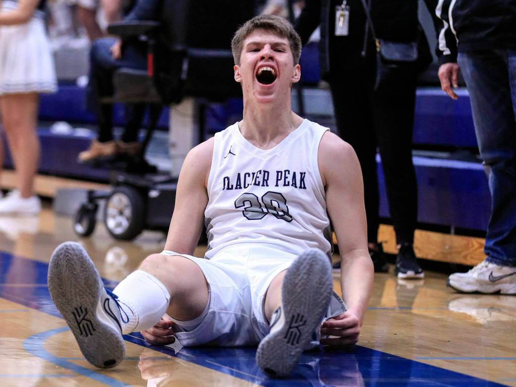 Glacier Peaks Bobby Siebers celebrates a 3-pointer and drawing a foul in the second quarter Friday evening at Glacier Peak High School in Snohomish, Washington on January 21, 2022. The Grizzles won 57-54. (Kevin Clark / The Herald)