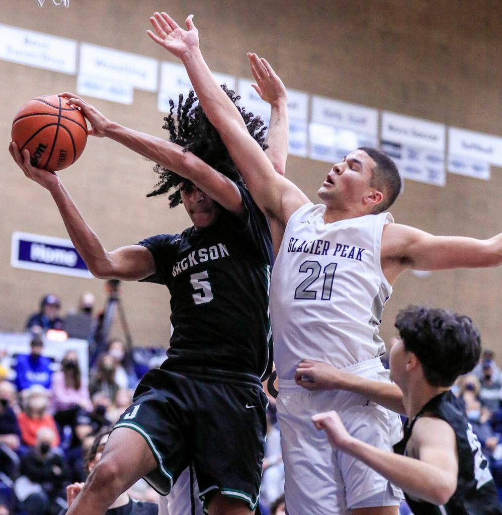 Jacksons Sylas Williams wins a rebound against Glacier Peaks Torey Watkins Friday evening at Glacier Peak High School in Snohomish, Washington on January 21, 2022. The Grizzles won 57-54. (Kevin Clark / The Herald)