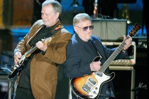 FILE - Bob Spalding, left, and Don Wilson of The Ventures perform at the Rock and Roll Hall of Fame Induction Ceremony in New York, March 10, 2008. Don Wilson, co-founder and rhythm guitarist of the instrumental guitar band The Ventures, has died. He was 88. The News Tribune reports Wilson died Saturday, Jan. 22, 2022 in Tacoma of natural causes, surrounded by his four children. (AP Photo/Jason DeCrow)