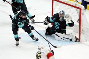 Seattle Kraken goaltender Philipp Grubauer (31) looks on as Kraken center Calle Jarnkrok (19) clears the puck during the second period of an NHL hockey game against the Florida Panthers, Sunday, Jan. 23, 2022, in Seattle. (AP Photo/Ted S. Warren)