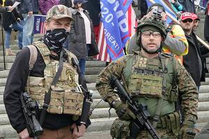 FILE - In this Jan. 6, 2021, file photo at the Capitol in Olympia, Wash., two men stand armed with guns at a protest supporting President Donald Trump and against the counting of electoral votes in Washington, DC, affirming President-elect Joe Biden's victory. The open carry of guns and other weapons would be banned on the Capitol campus and at or near any permitted public demonstration across Washington under a measure being considered by Washington lawmakers. (AP Photo/Ted S. Warren, File)