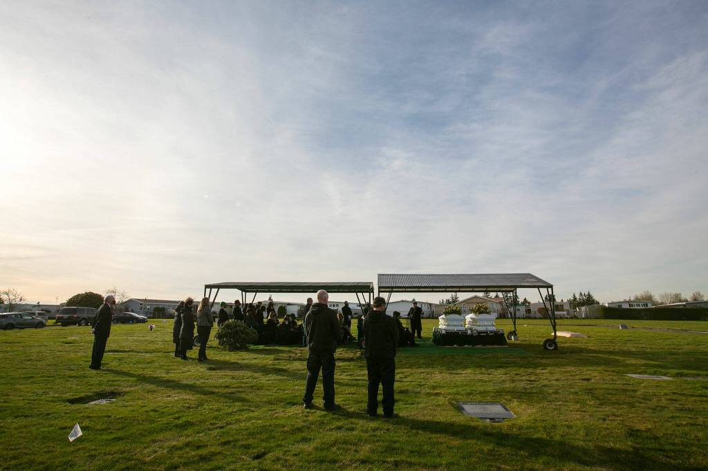 Mourners gather for the funeral of Adriana and Mariel Gil Friday, Jan. 28, 2022, at Cypress Lawn Memorial Park in Everett. (Ryan Berry / The Herald)