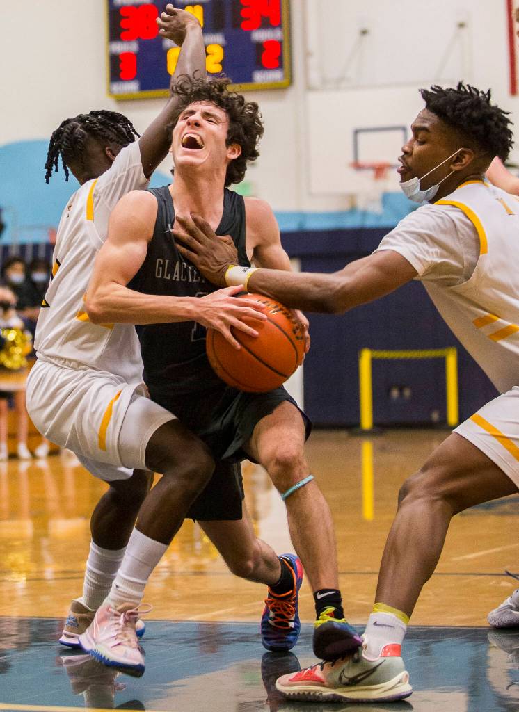 Glacier Peaks Aidan Davis yells while being fouled by Mariners Dakota Joseph during the game on Tuesday, Jan. 25, 2022 in Everett, Washington. (Olivia Vanni / The Herald)