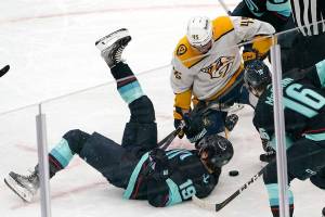 Seattle Kraken's Calle Jarnkrok (19) tumbles in front of Nashville Predators' Alexandre Carrier in the first period of an NHL hockey game Tuesday, Jan. 25, 2022, in Seattle. (AP Photo/Elaine Thompson)