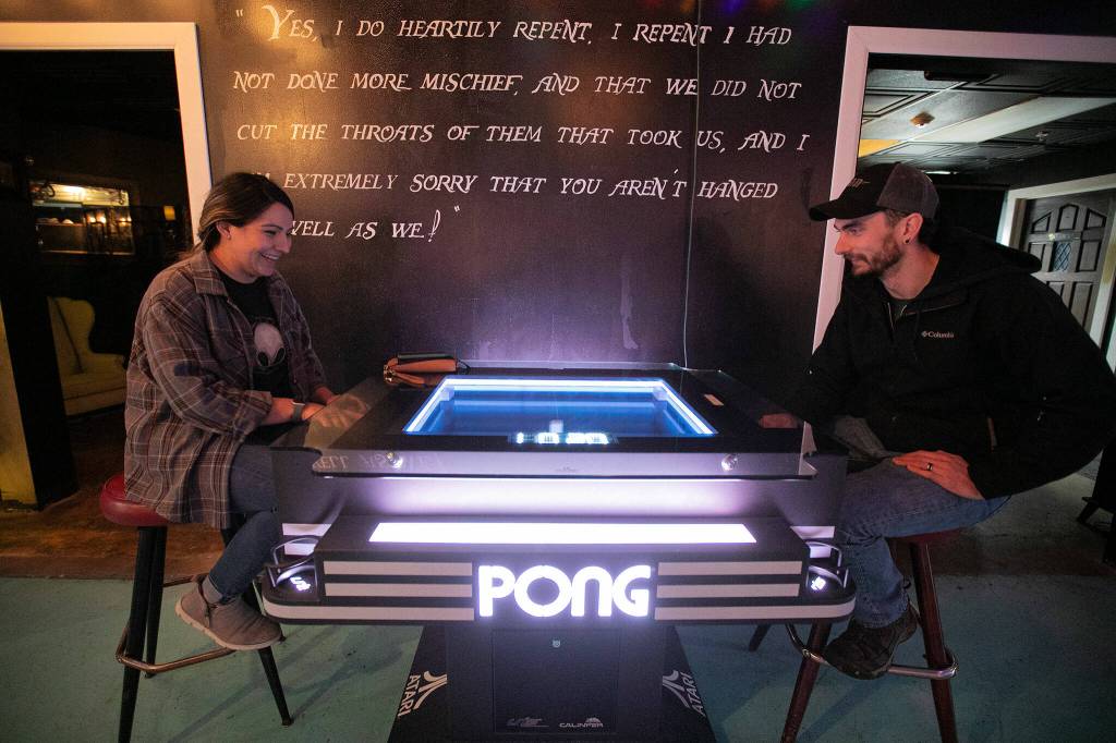 Christina and Ryan Sharpe play Pong in the game room Thursday at Vessel Taphouse in Lynnwood. (Ryan Berry / The Herald)