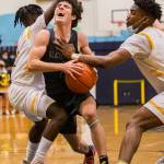 Glacier Peaks Aidan Davis yells while being fouled by Mariners Dakota Joseph during a game on Tuesday at Mariner High School in Everett. (Olivia Vanni / The Herald)