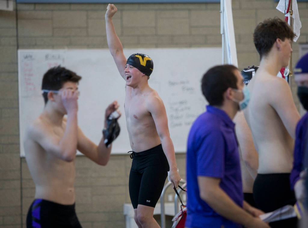 Braden Valliant cheers after a Lake Stevens teammate wins their race during the swim meet against Glacier Peak and Snohomish on Thursday in Snohomish. (Olivia Vanni / The Herald)