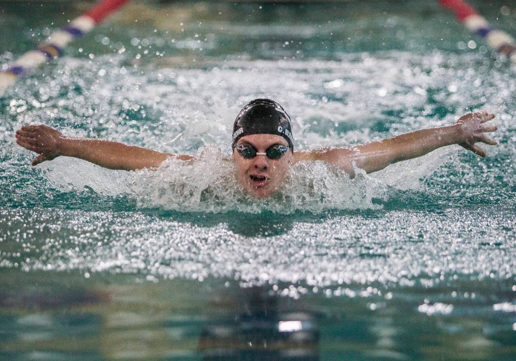 Lake Stevens Camden Belvins-Mohr competes in the 100-yrd butterfly during a swim meet against Glacier Peak and Snohomish on Thursday in Snohomish. (Olivia Vanni / The Herald)