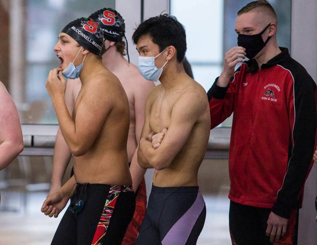 Snohomish swimmers cheer on their team during a swim meet against Lake Stevens and Glacier Peak on Thursday in Snohomish. (Olivia Vanni / The Herald)