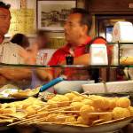 Diners sample an assortment of Venetian munchies at a cicchetti bar. (Rick Steves Europe)