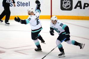 Seattle Kraken's Adam Larsson (6) celebrates with Calle Jarnkrok after scoring the winning goal in the overtime period of an NHL hockey game against the Pittsburgh Penguins in Pittsburgh, Thursday, Jan. 27, 2022. (AP Photo/Gene J. Puskar)