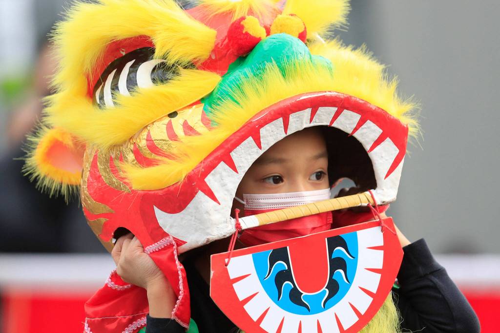 Members of Master David F. Leong Dragon and Lion Dance Group bring in the Lunar New Year in Edmonds on Saturday. (Kevin Clark / The Herald)