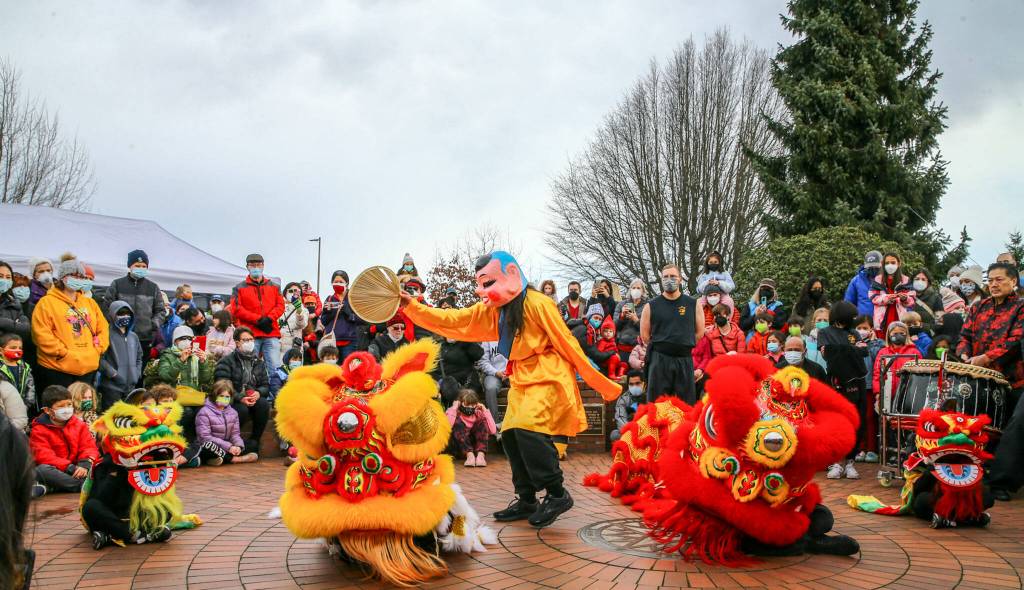 Members of Master David F. Leong Dragon and Lion Dance Group bring in the Lunar New Year in Edmonds on Saturday. (Kevin Clark / The Herald)