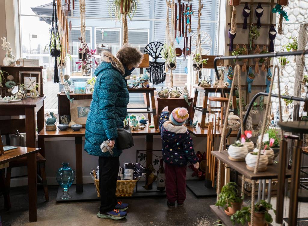 Linda Torretta (left) and Cordelia Toretta, 3, browse the gifts at Monkey Fist Market in Everett. (Olivia Vanni / The Herald)