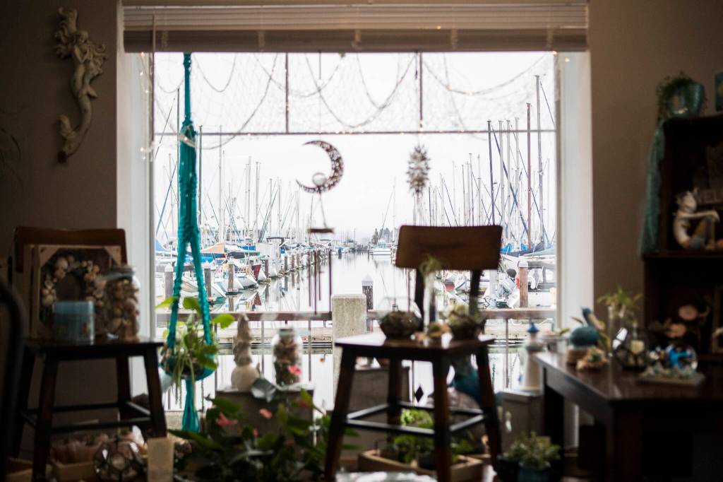 The Everett Marina visible from the Monkey Fist Market display window on Wednesday, Jan. 26, 2022 in Everett, Washington. (Olivia Vanni / The Herald)