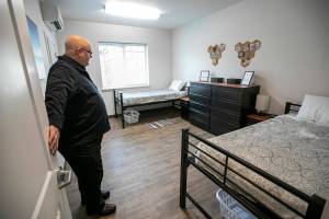 Executive Director Edmund Smith stands inside one of the living quarters Friday, Jan. 28, 2022, at the new Holman Recovery Center in Smokey Point, Washington. Smith said most rooms are for two occupants, though some are designated for only one. (Ryan Berry / The Herald)