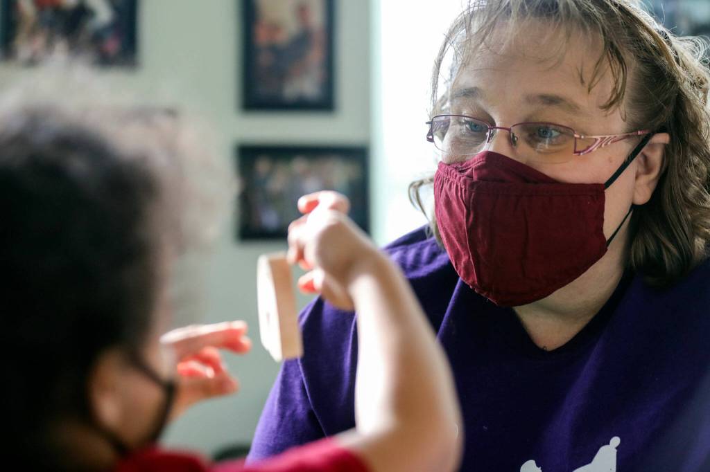 Antonio (left), 3, and Dani Hanson-Hooten identify toys Jan. 28 at the Edmonds Lutheran Learning Center. (Kevin Clark / The Herald)