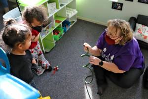 AJ, 2, left, and Antonio, 3, recoil from a toy snake held by Dani Hanson-Hooten Friday morning at the Edmonds Lutheran Learning Center in Edmonds, Washington on January 28, 2022. (Kevin Clark / The Herald)