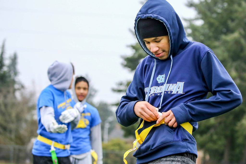 LaVanta McMillan, 15, reattaches his flag during practice Jan. 16 at Harbour Pointe Middle School in Mukilteo. (Kevin Clark / The Herald)