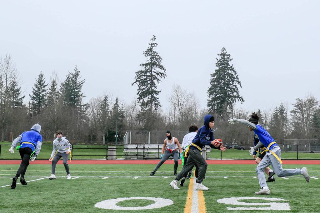The Everett Elite Flag Football 14-under team practices Jan. 16 at Harbour Pointe Middle School in Mukilteo. (Kevin Clark / The Herald)