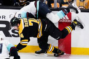 Boston Bruins left wing Jake DeBrusk (74) checks Seattle Kraken center Mason Appleton, rear, during the first period of an NHL hockey game, Tuesday, Feb. 1, 2022, in Boston. (AP Photo/Charles Krupa)