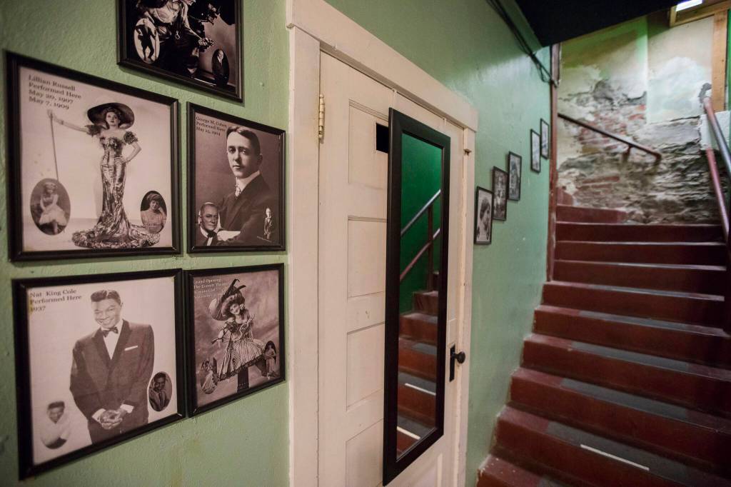 Posters cover the walls along the stairway leading into the green room at the Historic Everett Theatre. (Olivia Vanni / The Herald)
