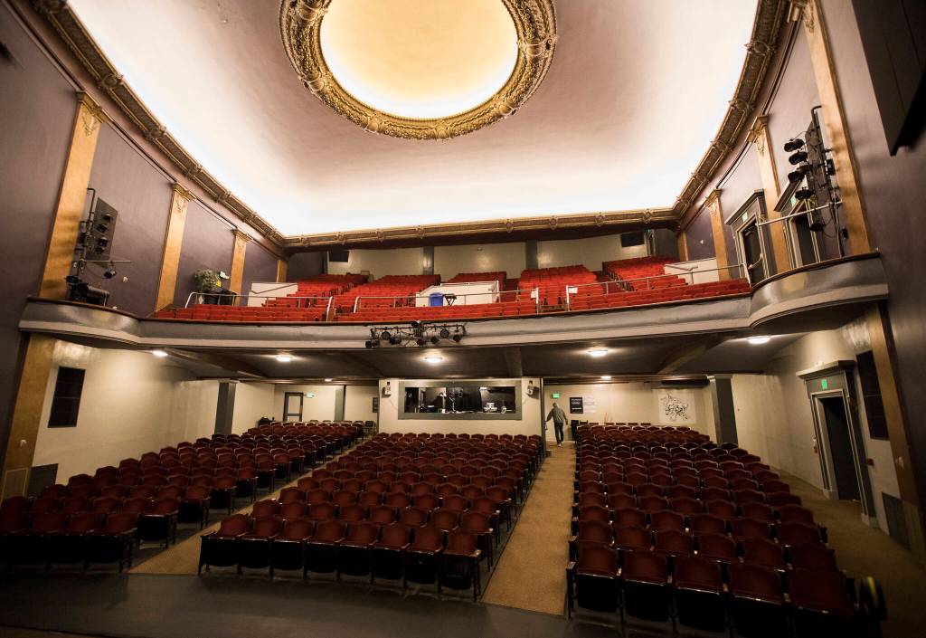 Curt Shriner walks into the technical booth at the Historic Everett Theatre. (Olivia Vanni / The Herald)