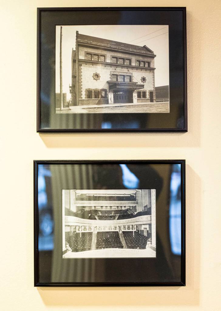 Historic photos of the original Everett Theater hang in the lobby. (Olivia Vanni / The Herald)