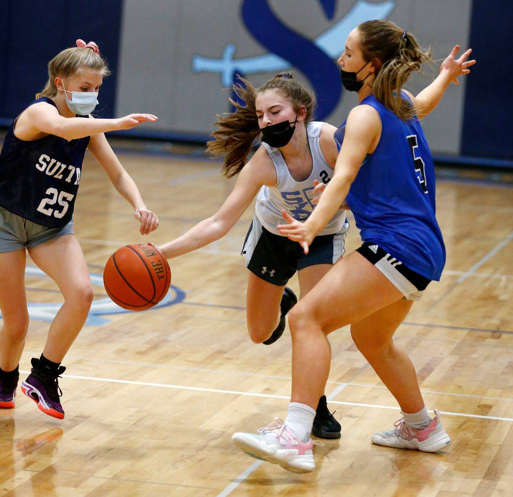 Sultan freshman Wendy Asper gets surrounded by defenders during practice Thursday at Sultan High School. (Ryan Berry / The Herald)