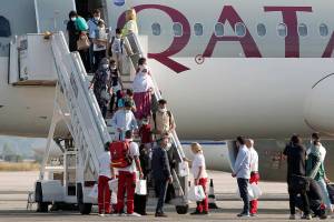 Afghan evacuees disembark the plane and board a bus after landing at Skopje International Airport, North Macedonia, on Wednesday, Sept. 15, 2021. North Macedonia has hosted another group of 44 Afghan evacuees on Wednesday where they will be sheltered temporarily till their transfer to final destinations. (AP Photo/Boris Grdanoski)