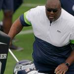 Seattle Seahawks defensive line and assistant head coach Clint Hurtt, right, runs a drill during NFL football practice Tuesday, June 15, 2021, in Renton, Wash. (AP Photo/Ted S. Warren)