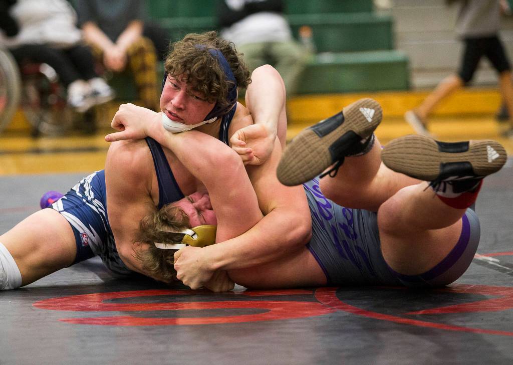 Glacier Peaks Jacob Erickson (left) attempts to pin Lake Stevens Koen Mattern during the 4A sub-regional tournament 220-pound championship match on Saturday at Henry M. Jackson High School in Mill Creek. (Olivia Vanni / The Herald)