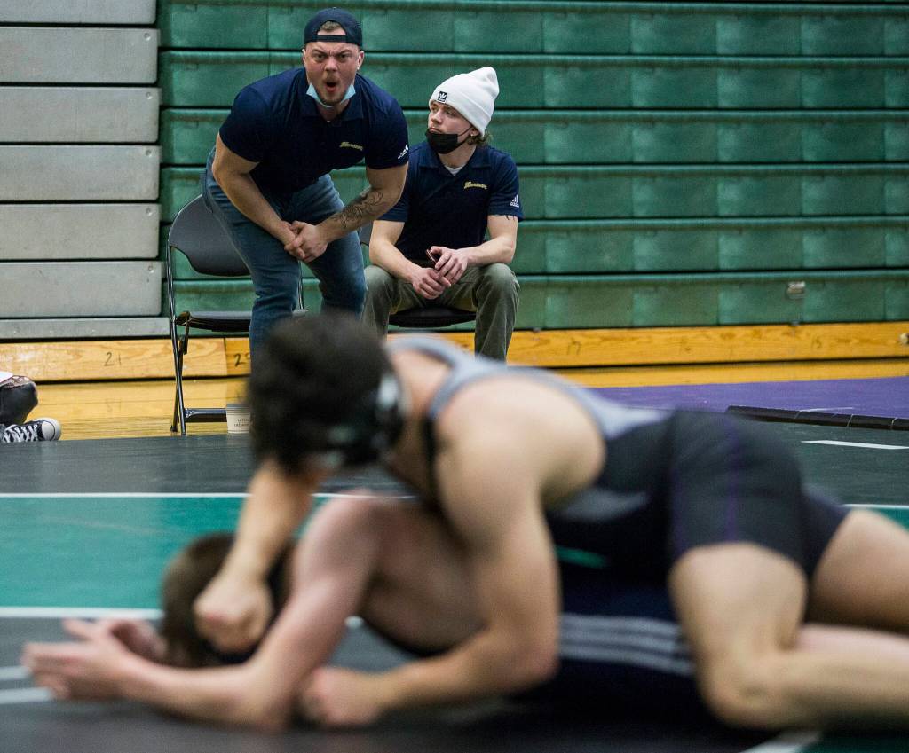 A Mariner coach yells instructions to his wrestler during a 4A sub-regional match on Saturday at Henry M. Jackson High School in Mill Creek. (Olivia Vanni / The Herald)