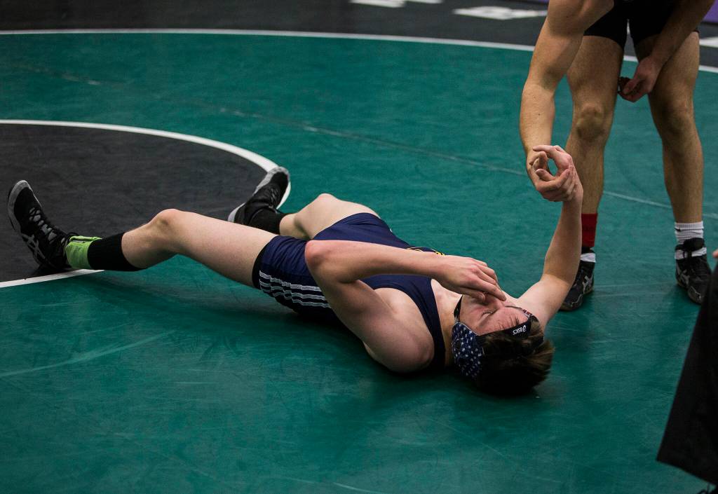 Kamiaks Simon Ross (top) helps Mariners Theo Waldner up after beating him in a 4A sub-regional match on Saturday at Henry M. Jackson High School in Mill Creek. (Olivia Vanni / The Herald)