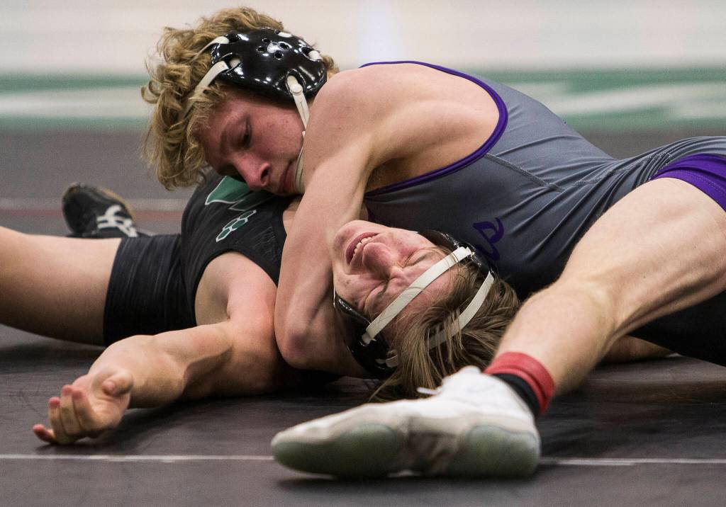 Lake Stevens Kael Anderson (top) pins Jacksons Jonah Justice to win a 4A sub-regional match on Saturday at Henry M. Jackson High School in Mill Creek. (Olivia Vanni / The Herald)