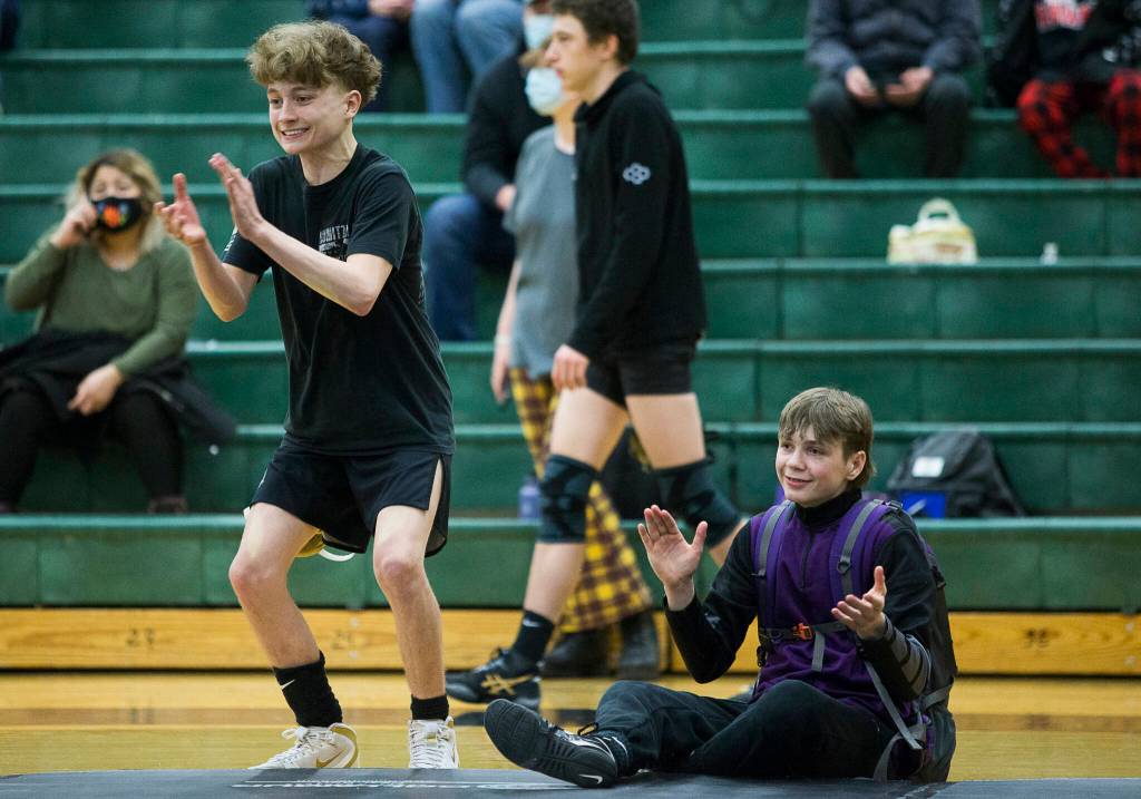 Lake Stevens Troy Valentine and Jacob Christanson cheer on a teammate during a 4A sub-regional match on Saturday at Henry M. Jackson High School in Mill Creek. (Olivia Vanni / The Herald)