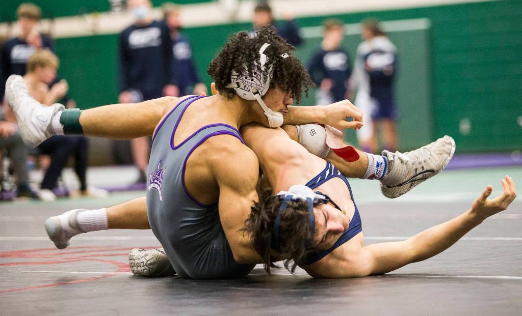 Lake Stevens Jackson Balmer (left) attempts to flip Glacier Peaks Spencer Dhondt to his back during a 4A sub-regional match on Saturday at Henry M. Jackson High School in Mill Creek. (Olivia Vanni / The Herald)