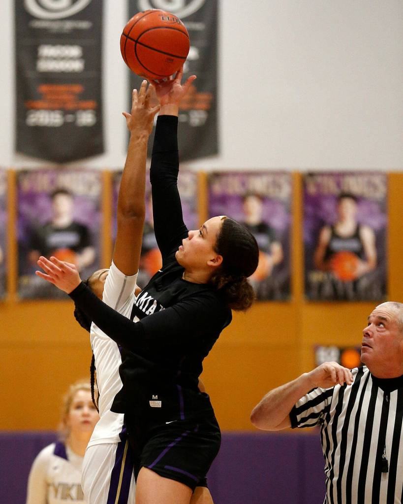 Kamiaks Nayella George wins the opening tip against Lake Stevens Monday, Feb. 7, 2022, at Lake Stevens High School in Lake Stevens, Washington. (Ryan Berry / The Herald)