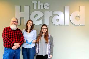 The Daily Herald received the 2022 Democracy in Action award Saturday from the League of Women Voters of Snohomish County. Photographed Jon Bauer, Katie Hayes and Rachel Riley in Everett, Washington on February 10, 2022.  (Kevin Clark / The Herald)