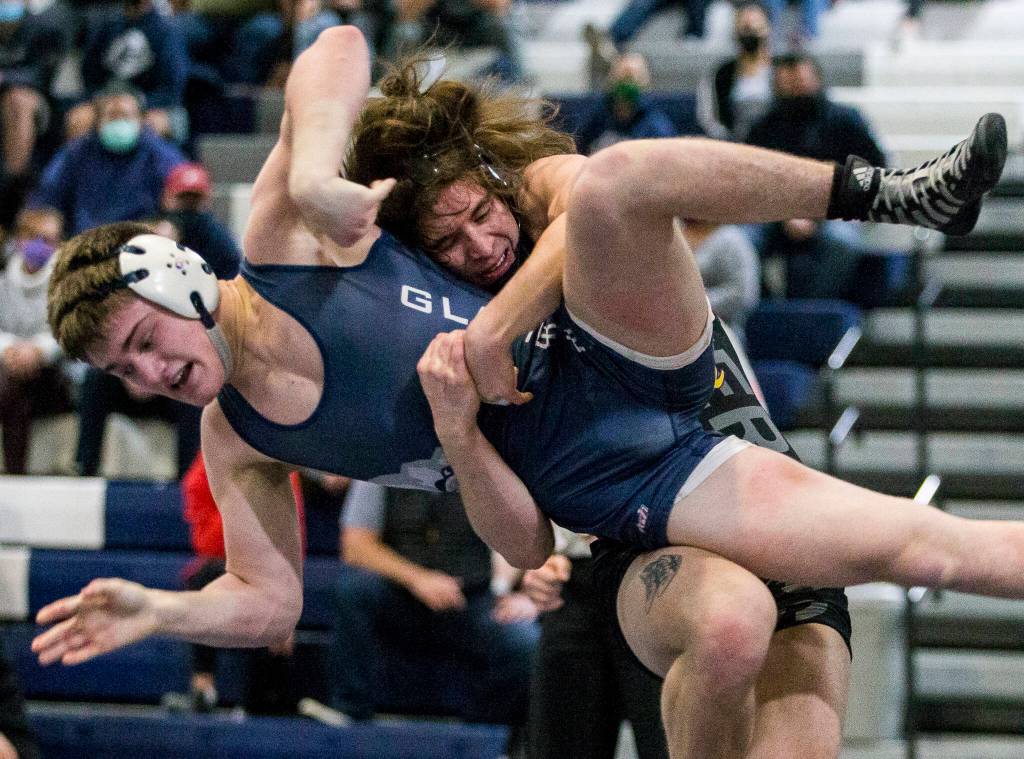 Lake Stevens senior Tyler Fouts lifts Glacier Peak sophomore Gil Mossburg during a dual meet last month. (Olivia Vanni / The Herald)