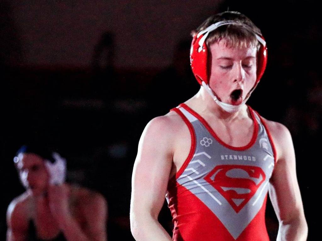Stanwood junior Tyler Rhue celebrates his victory during a dual meet last month. (Kevin Clark / The Herald)