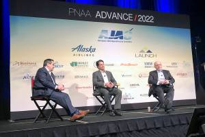 Richard Aboulafia (left) and Kevin Michaels (center), both managing directors at AeroDynamic Advisory, and Ronald Epstein (right), senior equity analyst at Bank of America Merrill Lynch, took the stage Wednesday at the 21st annual Pacific Northwest Aerospace Alliance. This year's event took place at the Lynnwood Convention Center. (Janice Podsada / The Herald)