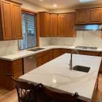 A new engineered stone counter and backsplash, installed over top of the existing surfaces, created a whole new look for this Everett kitchen.