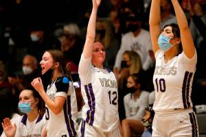 The Lake Stevens bench reacts to a teammate’s three point shot against Kamiak Monday, Feb. 7, 2022, at Lake Stevens High School in Lake Stevens, Washington. (Ryan Berry / The Herald)