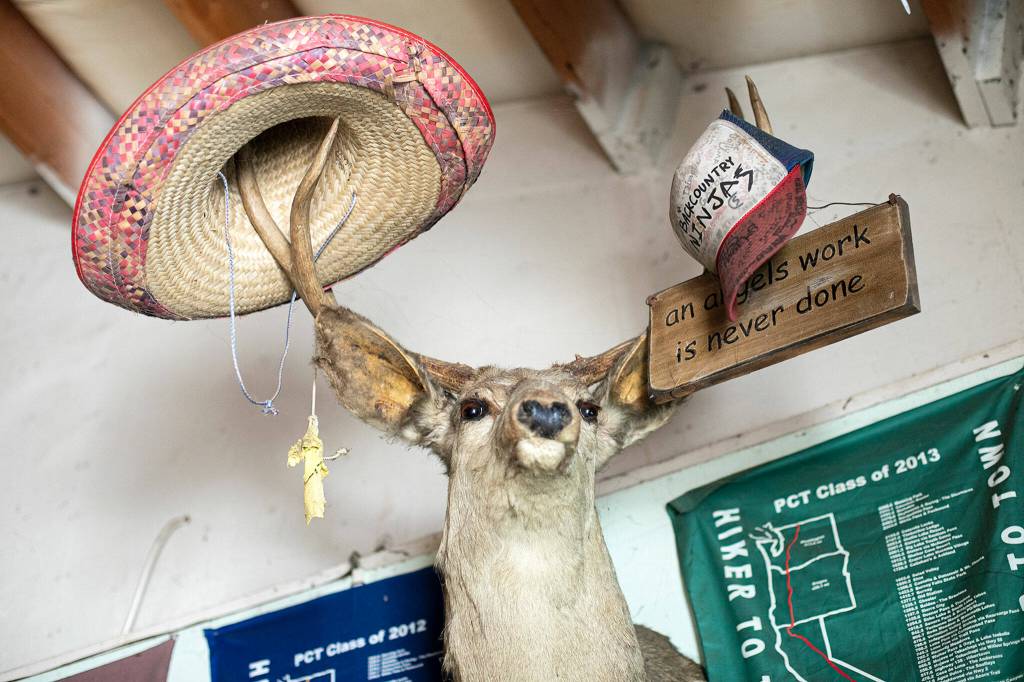 Memorabilia left by Pacific Crest Trail hikers on the walls of the Dinsmores haven in Baring. (Ryan Berry / The Herald)